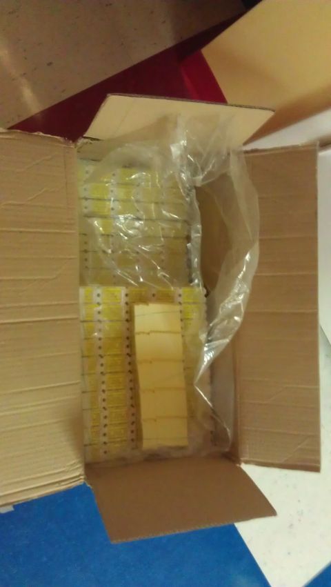 1994 Ford Bronco - A box contains numerous yellow parts, some stacked and wrapped in plastic.