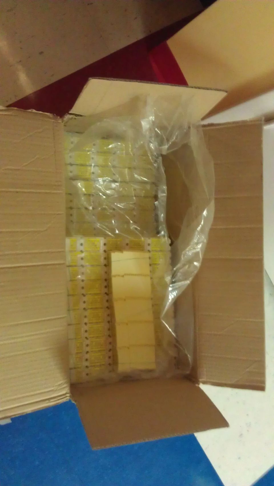 Box of yellow parts in plastic packaging