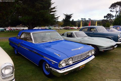 1994 Ford Bronco - A bright blue 1963 Ford Falcon Futura coupe is displayed at a car show, alongside other vintage vehicles.