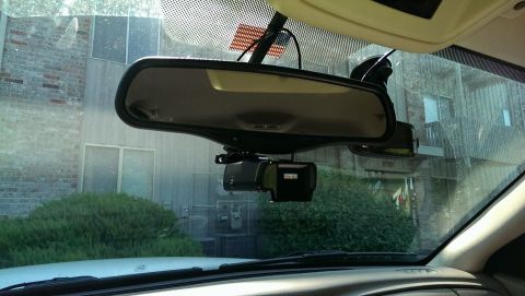 2000 Mercury Grand Marquis - Interior view of a vehicle's windshield showing a dashcam and rearview mirror.