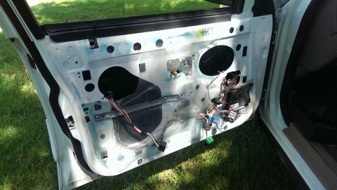2000 Mercury Grand Marquis - Interior of a car door with the panel removed, revealing the internal components and wiring.