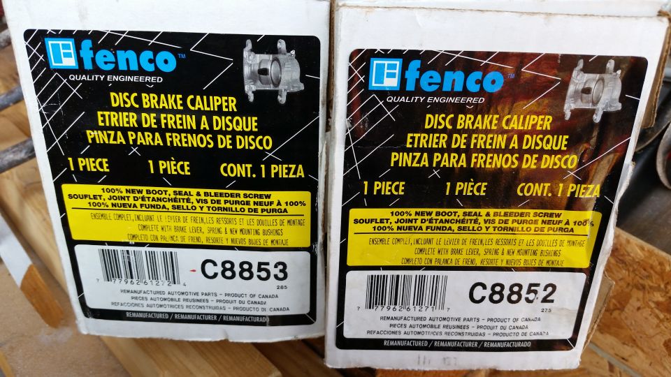 Two boxes of Fenco disc brake calipers, one labeled C8853 and the other C8852