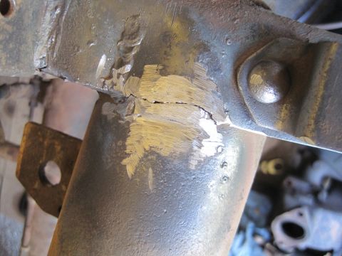 1946 Jeep Willys - Close-up of a damaged and repaired metal frame, likely from a vehicle's chassis.
