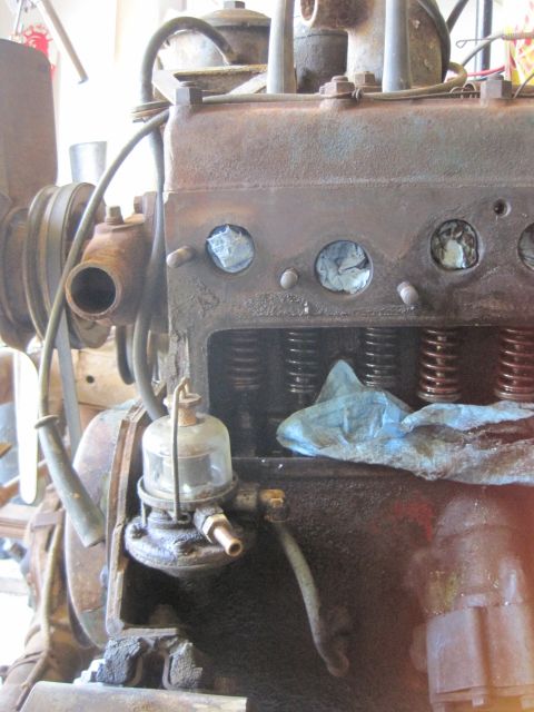 1946 Jeep Willys - Close-up of a weathered engine, showing internal components and a fuel filter assembly.