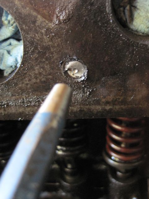 1946 Jeep Willys - The bolt hole in this engine cylinder head appears to be damaged, possibly from a stripped or broken bolt.