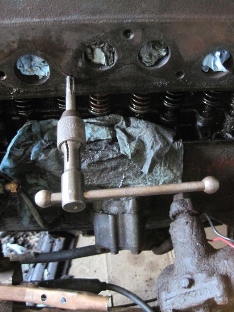 1946 Jeep Willys - Close-up of an engine block showing valve springs and a tool being used for maintenance.