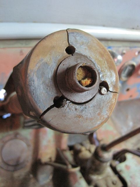 1946 Jeep Willys - Cracked wooden steering column housing, showing internal metal parts and some yellowed material.