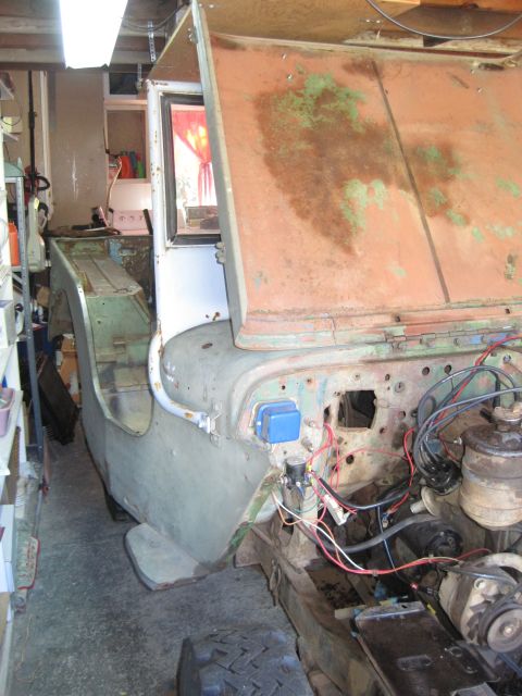 1946 Jeep Willys - Jeep body and engine components visible in a workshop environment with the hood open.