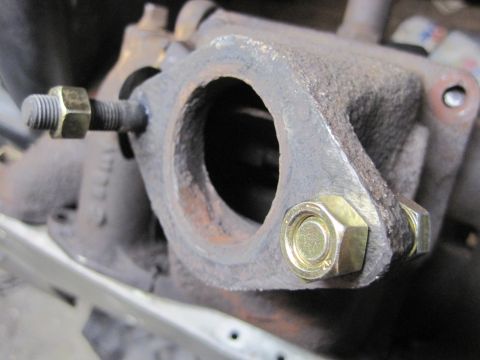 1946 Jeep Willys - Close-up view of an exhaust manifold part, showing newly installed bolts and nuts.