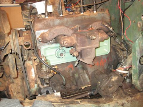 1946 Jeep Willys - Close-up view of a weathered engine, showing its various components and signs of age.