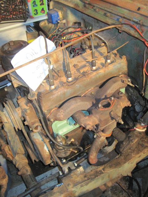 1946 Jeep Willys - Engine compartment with a paper note that says "Oil Coolant" is visible.
