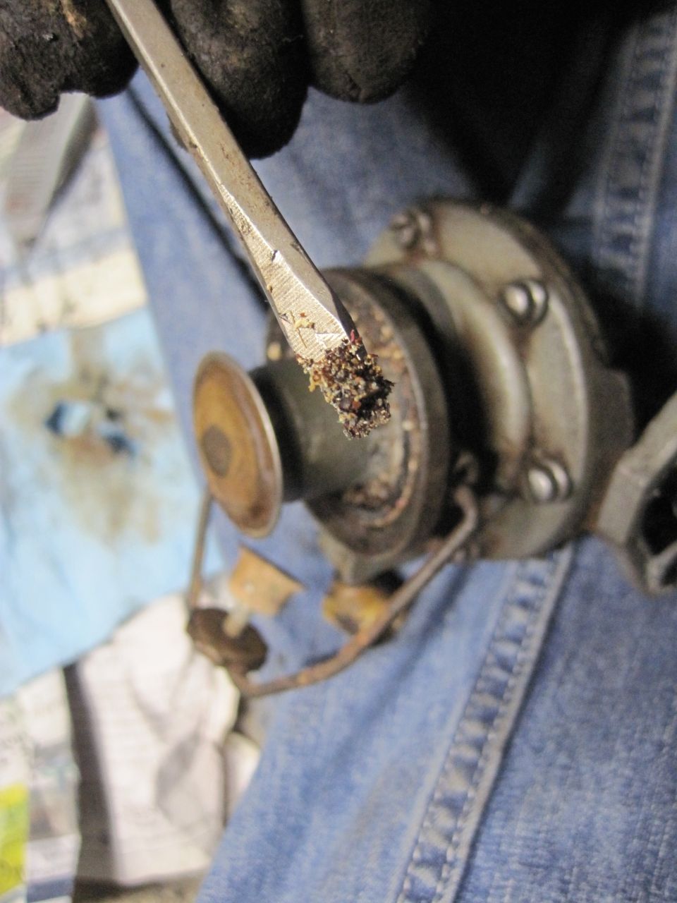 guy cleaning debris out of a distributor cap with a screwdriver