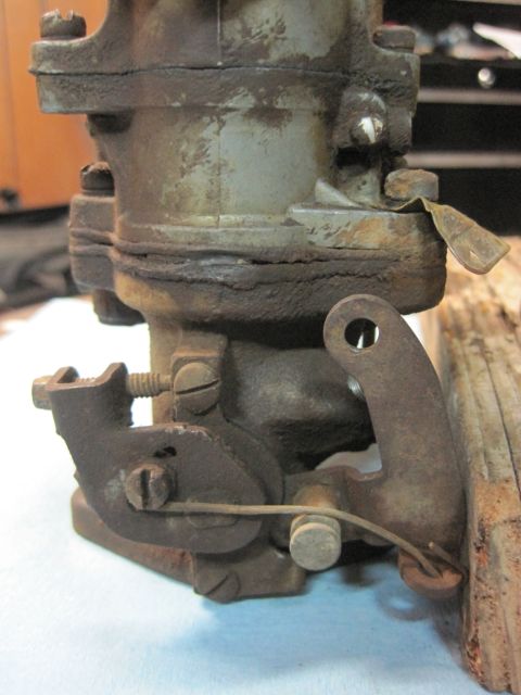1946 Jeep Willys - This is a close-up view of a carburetor, likely from an older vehicle, showing signs of wear and rust.