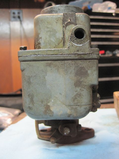 1946 Jeep Willys - A close-up view of a worn carburetor, showing its metallic components and signs of age.