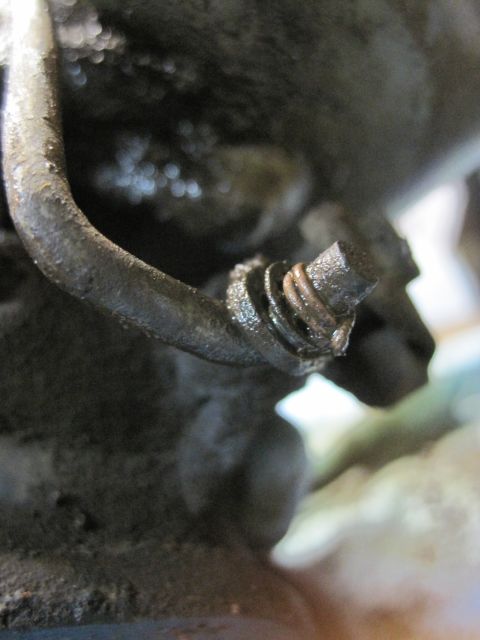 1946 Jeep Willys - A close-up view of a hose clamp on a greasy engine component, with a SuperMotors watermark visible.