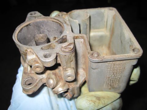 1946 Jeep Willys - Carburetor part shown in detail, held by a gloved hand.