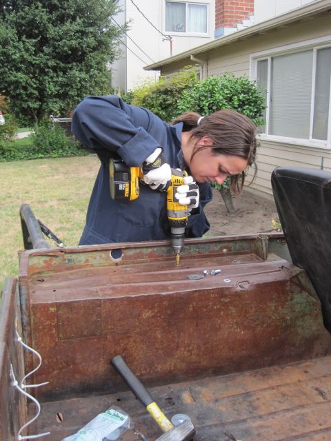 1946 Jeep Willys - Working on the rusty interior of an old vehicle with a drill.