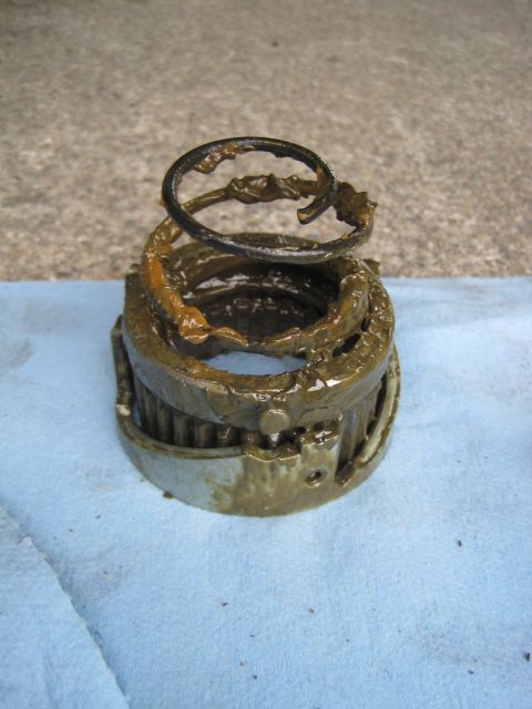 1946 Jeep Willys - A disassembled bearing assembly covered in old grease sits on a blue shop towel.