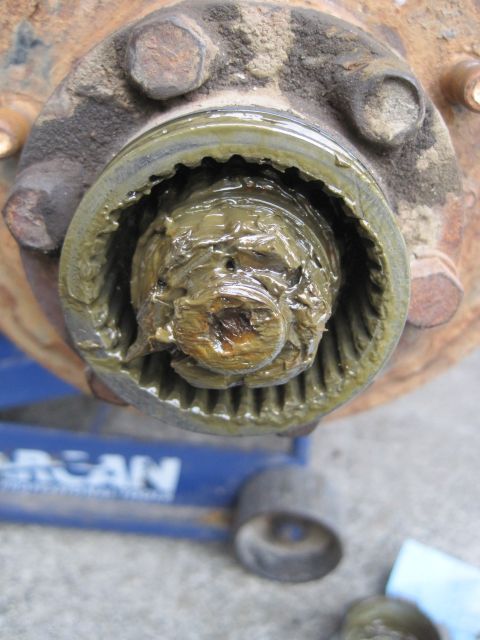 1946 Jeep Willys - A close-up view of a heavily greased wheel hub assembly, revealing its internal splined components.