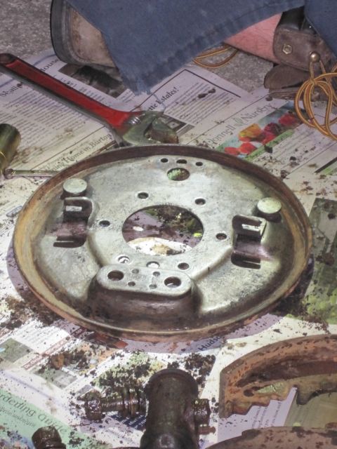 1946 Jeep Willys - A close-up view of a brake drum backing plate and associated parts, suggesting a vehicle repair or restoration project.