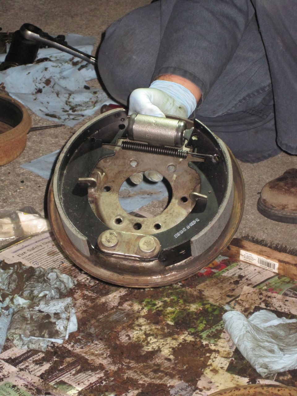 Brake drum assembly with brake shoes and wheel cylinder being serviced