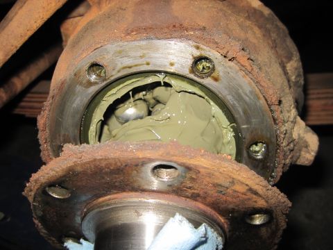 1946 Jeep Willys - Wheel bearing assembly packed with green grease, showing signs of rust and wear.