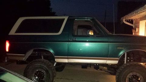 1996 Ford Bronco - This 1996 Ford Bronco features a lifted suspension and a two-tone paint scheme with a white removable top.