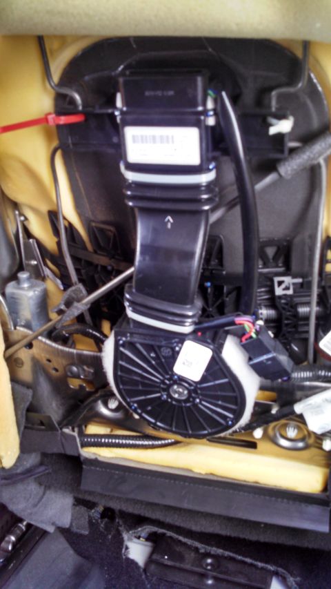 2009 Ford Expedition - Close-up of car seat's internal ventilation system components, including a fan and duct.