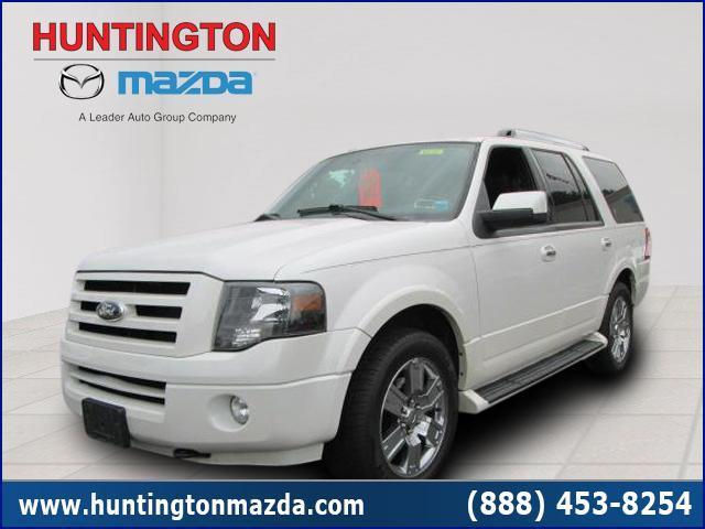 White Ford Expedition SUV parked, front passenger side visible. Dealership logos at top