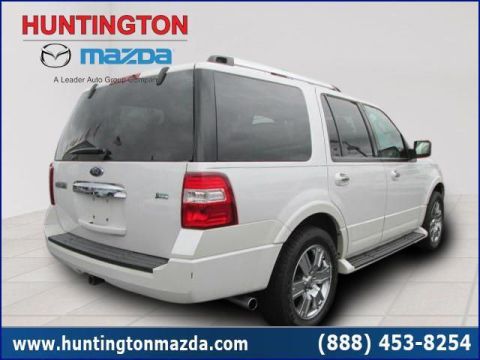 2009 Ford Expedition - White Ford Expedition SUV seen from the rear, showing its taillights and chrome bumper.