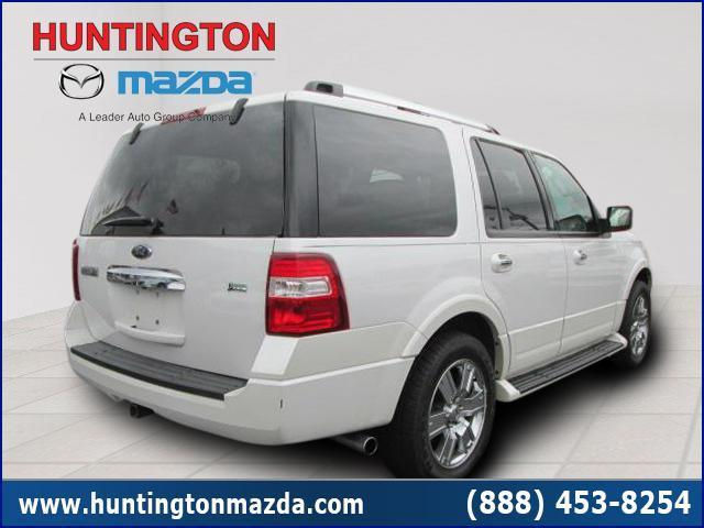Rear view of a white Ford Expedition SUV with chrome accents and running boards