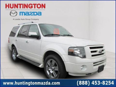 2009 Ford Expedition - A white 2009 Ford Expedition is shown from a three-quarter front angle in a dealership setting.