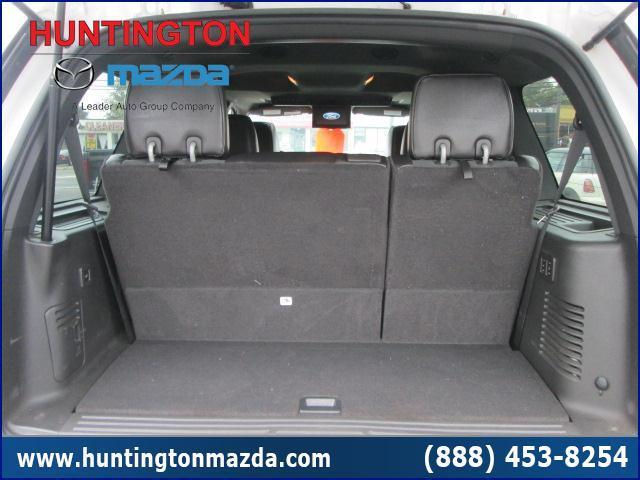 Black SUV trunk interior with folded down seats and side panel vents