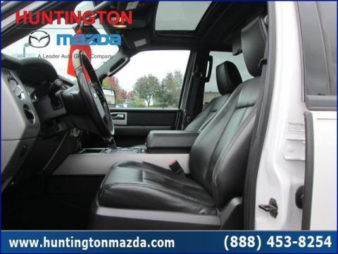 2009 Ford Expedition - The interior of a truck shows black leather seats and the center console.