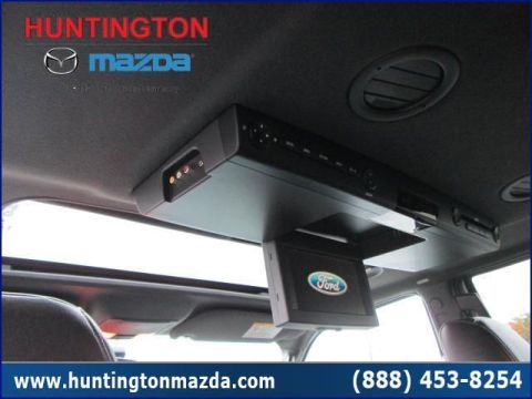 2009 Ford Expedition - The interior of a vehicle displays a drop-down entertainment system with a Ford logo.