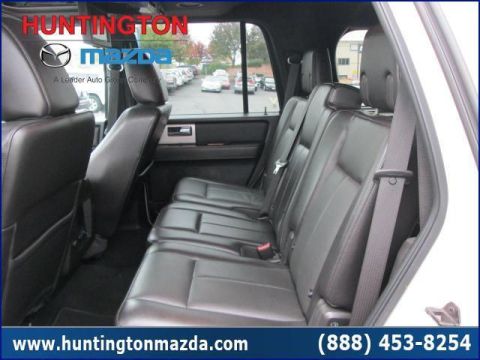 2009 Ford Expedition - The interior of a white SUV is shown, focusing on the rear seating area and door.