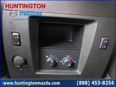2009 Ford Expedition - Close-up of the climate control panel and heated seat buttons inside a vehicle.