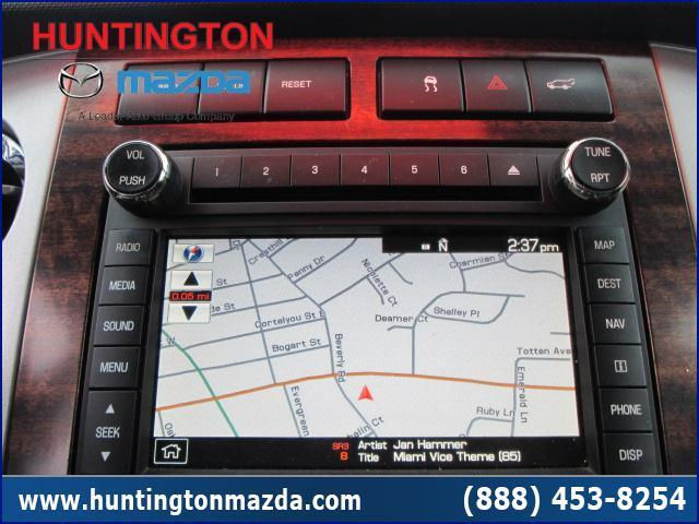 Car navigation screen showing map and song title 'Miami Vice Theme (85)' by Jan Hammer