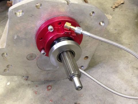 1986 Jeep Wagoneer - This image shows a clutch slave cylinder assembly connected to a transmission housing.