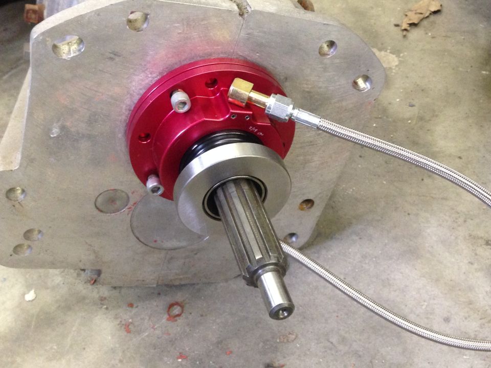 close-up of clutch slave cylinder with braided line attached to a transmission bell housing