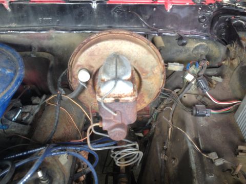 1978 Ford Bronco - Engine bay view of a brake booster and master cylinder assembly with visible wiring and hoses.