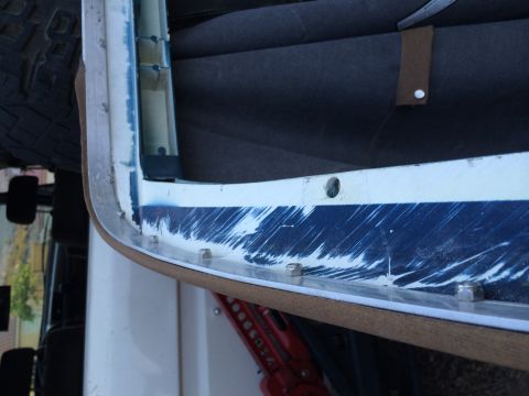 1995 Ford Bronco - Detail of a scuffed interior door panel, showing construction and wear.