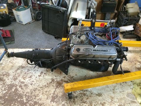1964 Ford Fairlane - A Ford Racing engine and transmission assembly is suspended on a yellow engine stand.