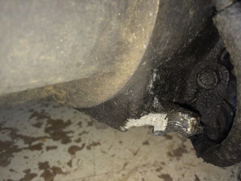 1964 Ford Fairlane - Close-up of a damaged metal part, showing significant wear and a broken edge.