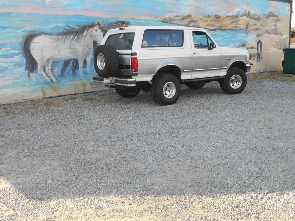 1994 Ford Bronco, 3q-front view, white and silver with spare tire on back