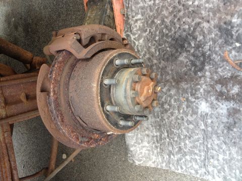 1978 Ford Bronco - Close-up of a heavily rusted vehicle brake rotor and hub assembly, showing significant wear and tear.