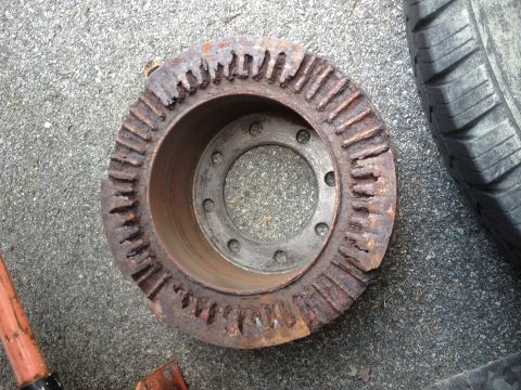 1978 Ford Bronco - This heavily rusted brake rotor shows significant damage to its outer teeth, indicating wear and tear.