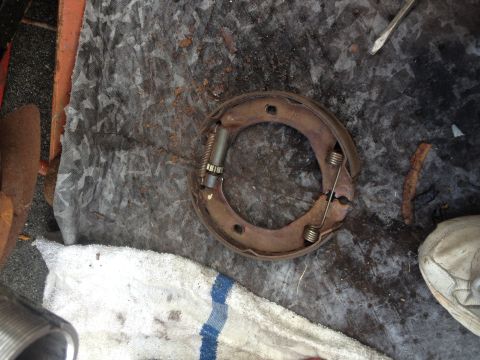 1978 Ford Bronco - A close-up view of a worn brake drum assembly, showing its internal components and signs of rust.