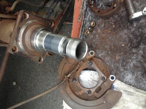1978 Ford Bronco - Disassembled rear axle hub and spindle assembly, likely for a truck or SUV, with brake parts nearby.