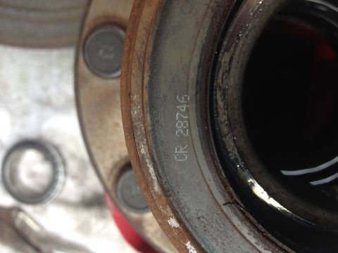 1978 Ford Bronco - A close-up view of a vehicle's wheel hub assembly, showing stamped identification numbers.